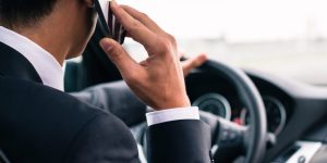 Man using his phone while driving the car